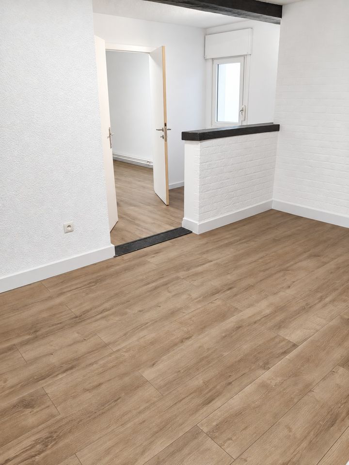 Renovated open room with new partition wall and laminate floor