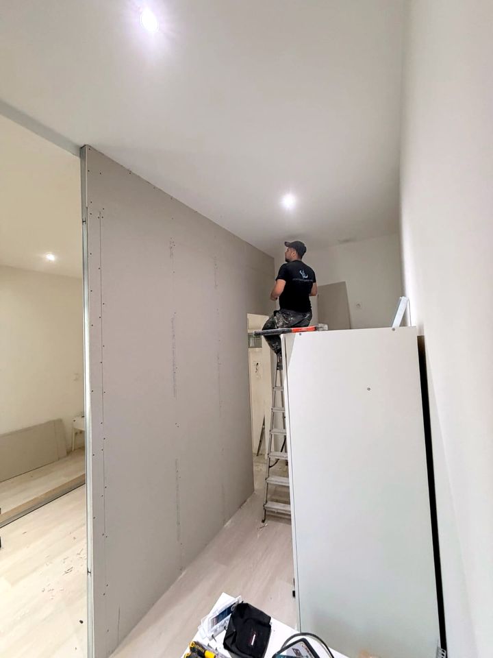 Drywall boards fixed and joints being filled
